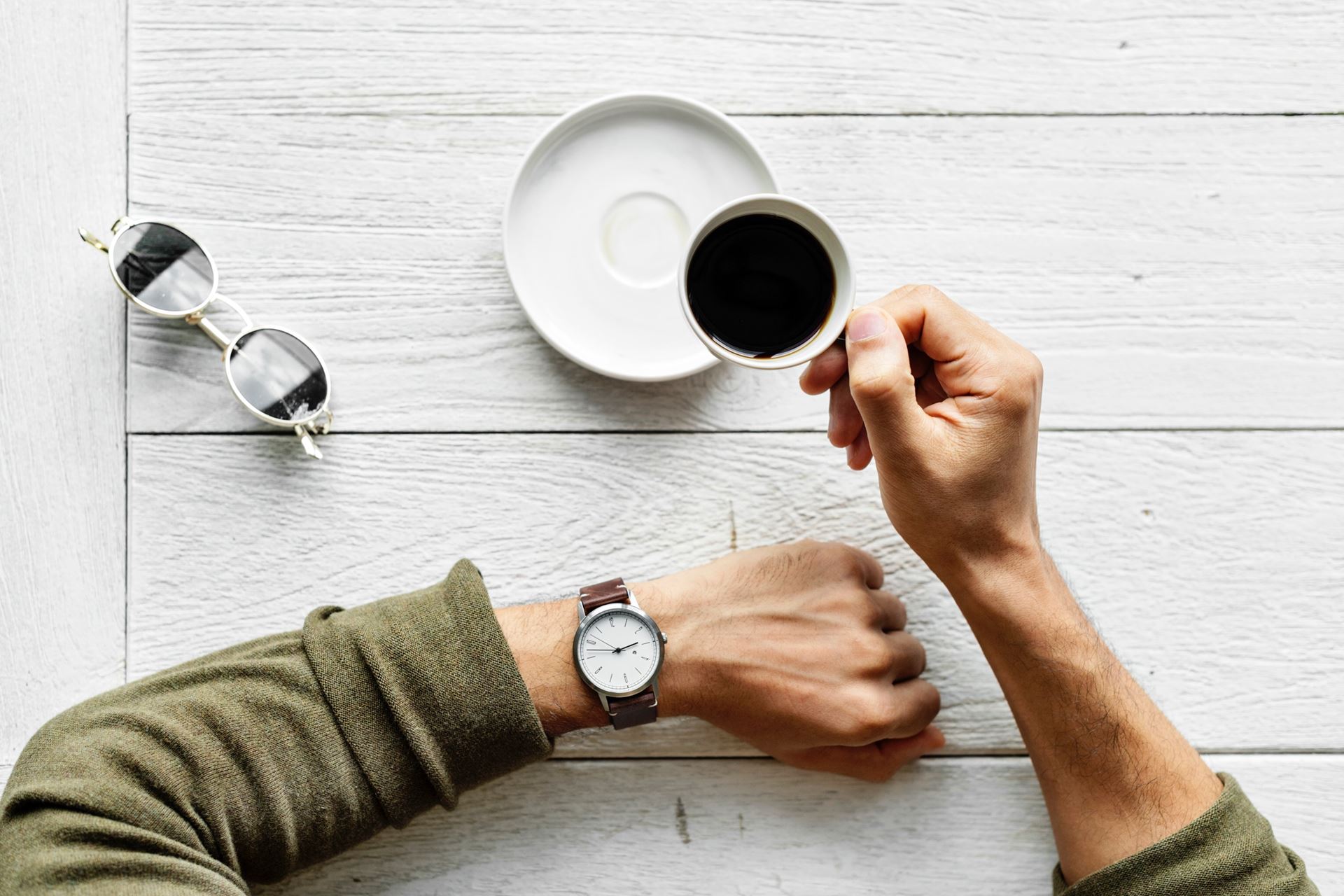 a man sitting on a table with a coffee